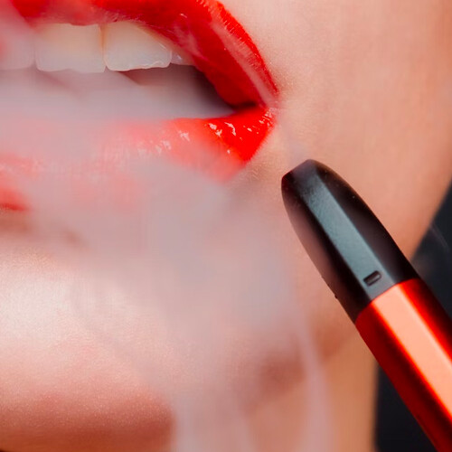 a photo of a woman exhaling vapor